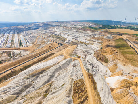 Aerial view of Hambach open pit mine with lignite mining operations and large-scale solar panel photovoltaic modules for renewable energy in Elsdorf, North Rhine-Westphalia, Germany.