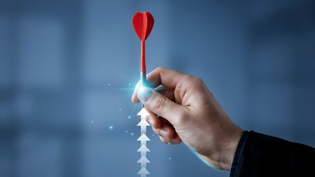 Businessman hand holding red dart with digital growth arrows