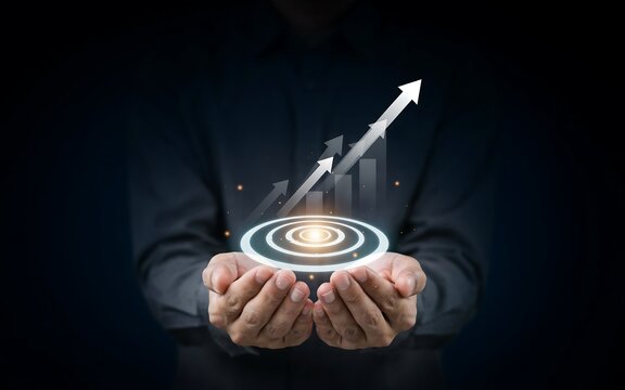 Businessman holding digital target with rising arrow graph