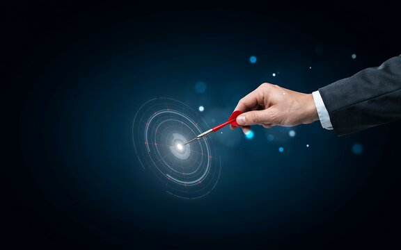 Businessman hand holding a dart hitting a digital target for business