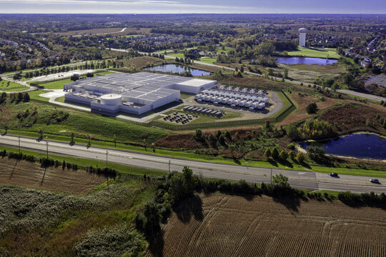 Aerial view of a data center facility surrounded by autumn foliage, ponds, and open fields in Volo, Illinois, United States.