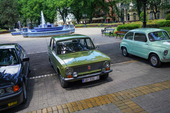Olive green Lada 1200 (soviet licensed Fiat 124 copy),USSR retro car parked near blue fountain in center of Subotica, Serbia, June 7, 2026