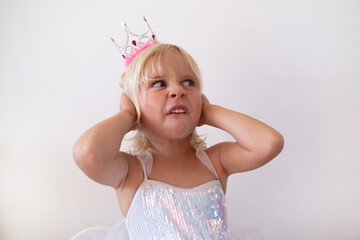 Disgusted Little Blonde Girl Wearing Princess Crown and Dress Pinching Nose  © RealPeopleStudio