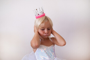 Disgusted Little Blonde Girl Wearing Princess Crown and Dress Pinching Nose  © RealPeopleStudio