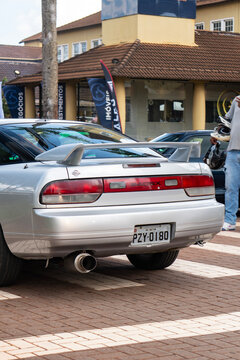 Silver Nissan 240SX Sports Car Rear View Detail Parked On Urban Paved Street Background