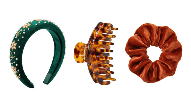 Green velvet headband with pearl flowers, tortoise shell hair claw clip, and orange velvet scrunchie isolated on a white background
