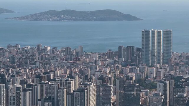City view with tall buildings near coastline in bright weather