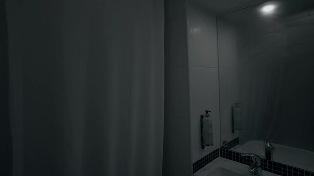 A misty hotel bathroom with a steamed-up mirror as the shower runs