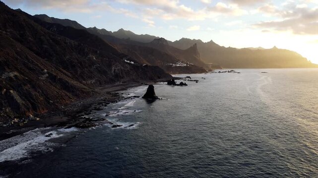 A dramatic sunset silhouette settles over the full length of the Anaga coastline as the sun nears the horizon. An extended cinematic hold for Tenerife travel edits.