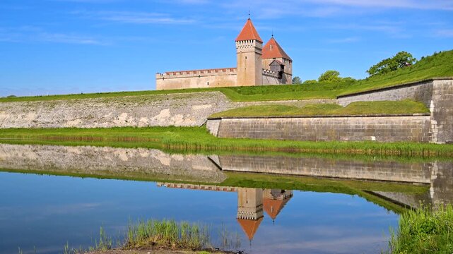 Kuressaare Castle and moat reflecting in water on Saaremaa Island