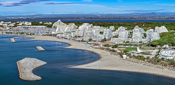 Aerial view of La Grande-Motte pyramidal architecture and Mediterranean coastline in south France 