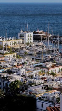 Panoramic vertical view of old town of Puerto de Mogan, harbor and colorful buildings, Gran Canaria, Canary Islands, Spain, Atlantic, Europe