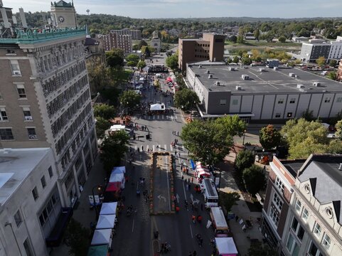 Hamilton, Ohio, United States - 09 October 2026: Aerial view of the Operation Pumpkin and Art Festival in downtown Hamilton, with street vendors, white tents, and crowds of people.