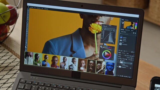 Laptop screen displaying photo editing software with portrait of African American man during retouching workflow. Suitable for digital marketing and creative agency tutorials