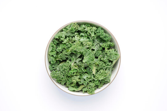 Bowl of kale on white top view
