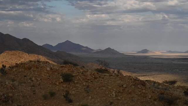 Clouds drifting across the sky, cloud shadows on the desert surface, time-lapse. Namibia