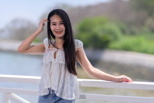 Young Woman Enjoying a Relaxing Day by the Water in Thailand