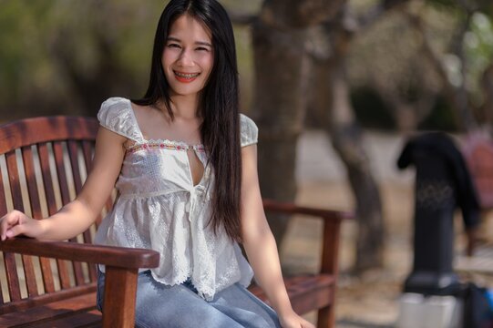 Young Woman Smiling on a Bench in Koh Si Chang, Chonburi Province