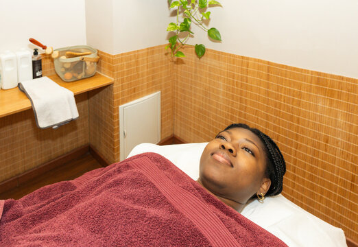 Woman relaxing on spa bed receiving wellness treatment