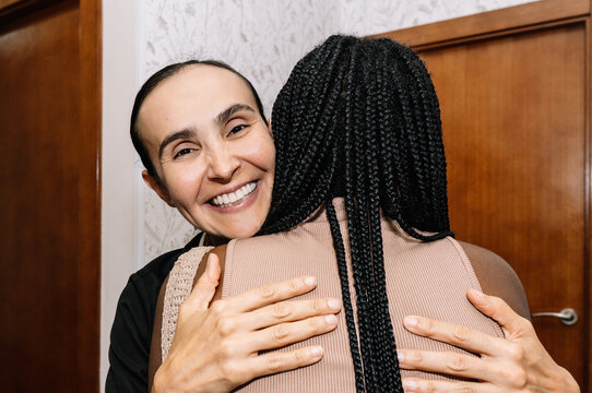 Happy woman embracing friend showing warmth and greeting