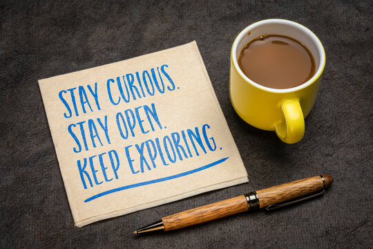 Stay curious. Stay open. Keep exploring. Inspirational motivational quote on a napkin. Concept of curiosity, open-mindedness, lifelong learning, exploration, and embracing new experiences.