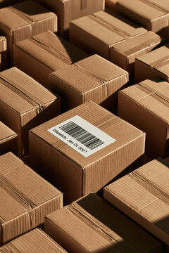 Many brown cardboard boxes are stacked together in a warehouse on January 1, 2027