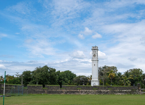 Matara Dutch Fort with clock tower and people playing cricket in Sri Lanka