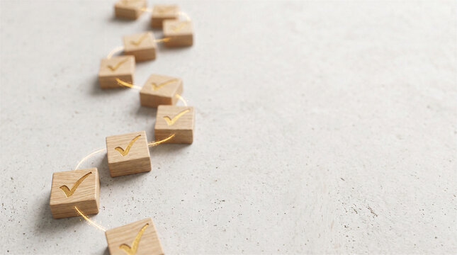 Wooden blocks with golden check marks arranged in a winding path on a textured light gray background
