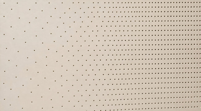 Beige perforated acoustic panel texture with round holes pattern background