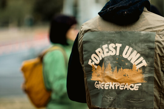 Details with the Greenpeace (Forest Unit) logo on the clothes of a person during a protest.