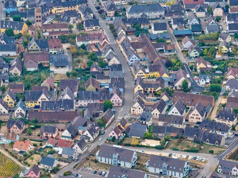 Aerial view of the historic town of Colmar, featuring traditional Alsatian architecture, colorful timber-framed houses, narrow streets, and tiled rooftops in Colmar, Grand Est, France.