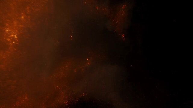 Glowing Embers and Ash Drift Through Dark Smoky Air in an Atmospheric Fiery Scene