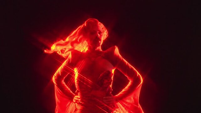 Charismatic drag queen posing confidently in red light