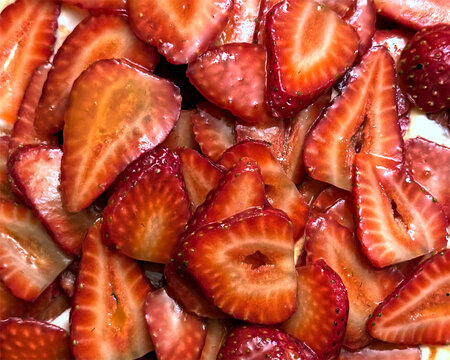 Sweet juicy honey glazed strawberries on a Pavlova dessert