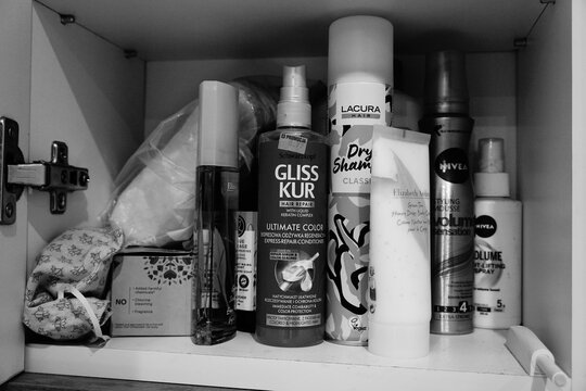Hair care products from Nivea, Gliss Kur and Lacura on a crowded bathroom cabinet shelf