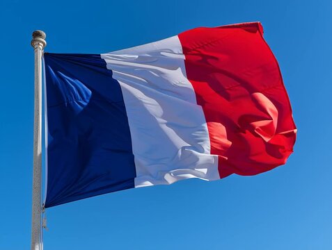 French flag waving in the wind against blue sky