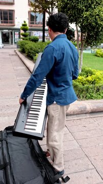 Street pianist packing his digital piano
