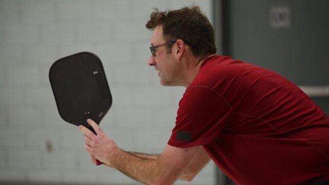 Co ed pickleball players in a modern gymnasium