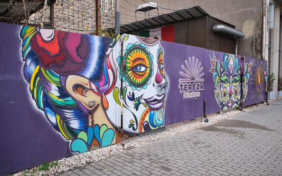 BUDAPEST, HUNGARY - JANUARY 4, 2024: Colorful Mexican-inspired street art and graffiti decorate the exterior wall of Tereza Mexican restaurant in Budapest, featuring stylized faces
