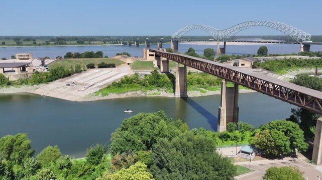 The Hernando de Soto (M) Bridge over the Mississippi and the Memphis riverfront by day. Drone footage, 4K.
