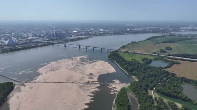 The Hernando de Soto (M) Bridge over the Mississippi and the Memphis riverfront by day. Drone footage, 4K.