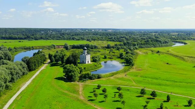 Russia, Bogolyubovo. Drone footage of Church of the Intercession on the Nerl. Orthodox church and a symbol of medieval Russia. Drone footage, Departure of the camera