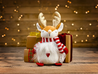 Christmas reindeer plush toy with gift boxes and lights © Olha Kapusniak
