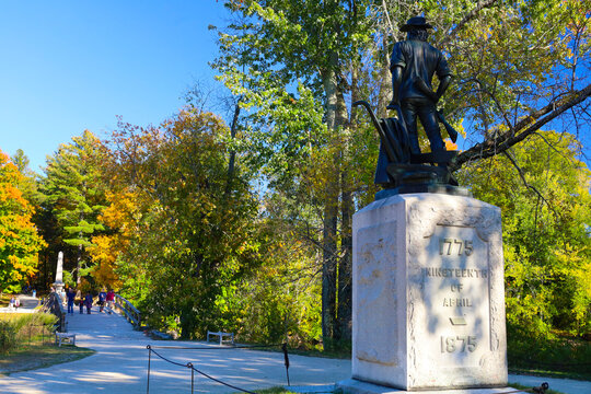 The Historic Minute Man Statue, Battle Monument and Old North Bridge Framed by Autumn Foliage in Concord, Massachusetts