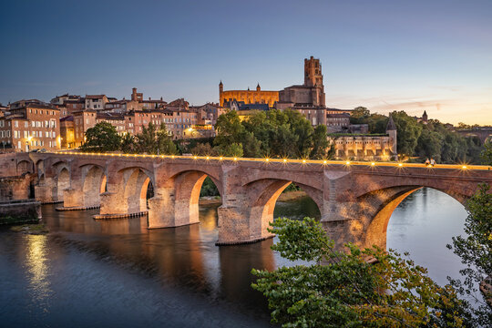 Albi, France - Albi featuring the Sainte-C&eacute;cile cathedral and the Pont Vieux (old bridge) over the river Tarn in the Occitanie region of France at sunset.