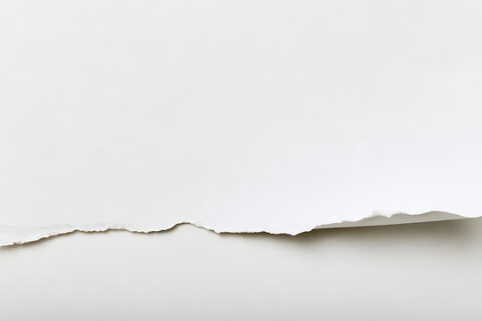 A large white paper corner that is ripped and has a folded edge