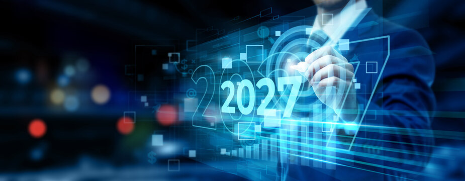 Businessman Pointing to 2027 Text on Digital Hologram Screen Displaying Future Targets