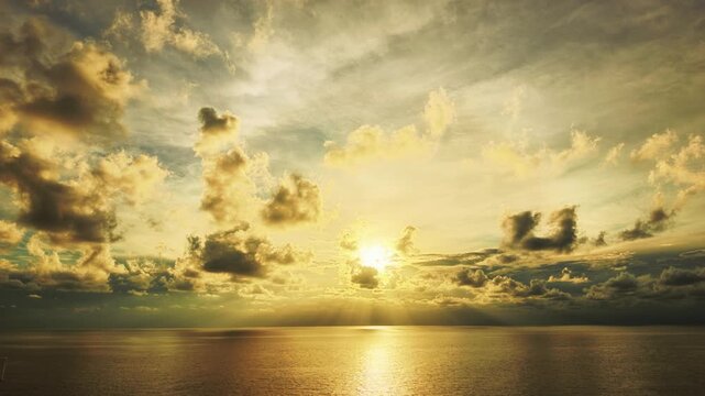 Brilliant Sunbeams Piercing Sunset Clouds Over Shimmering Golden Ocean Horizon
