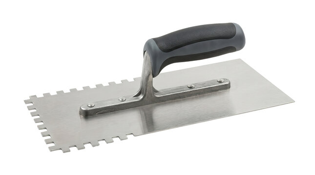 Close-up of notched trowel with black rubber handle for tiling and construction work