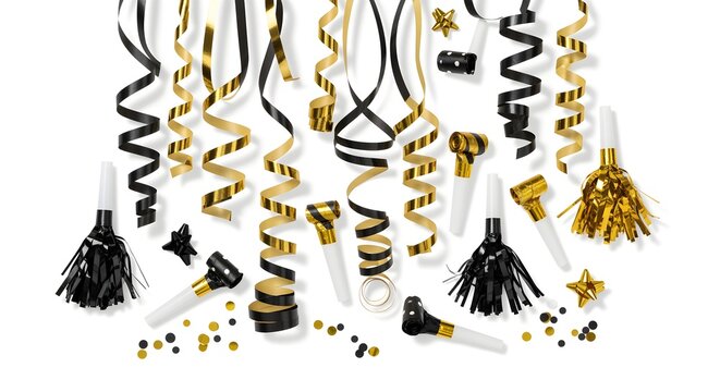 Black and gold New Year's Eve party streamers and noisemakers, isolated on white.